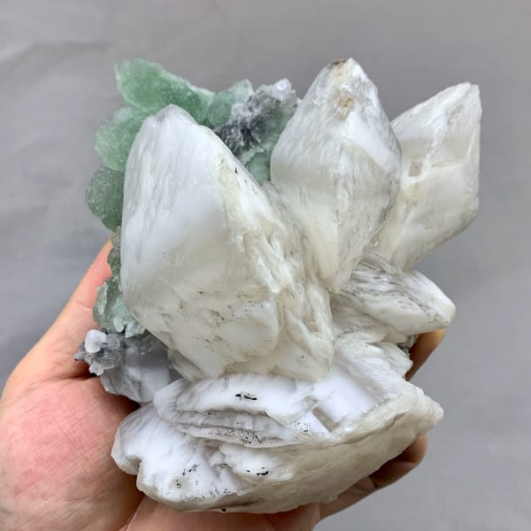 Huge shell-shaped white calcite crystals over green fluorite from Fujian, China, top view