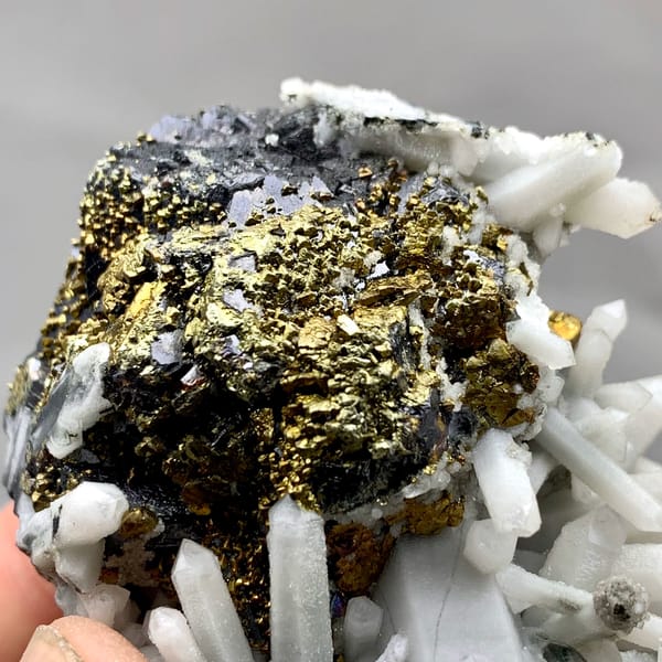 Golden chalcopyrite and black marmatite with white quartz from Inner Mongolia, China, close-up of the crystal faces
