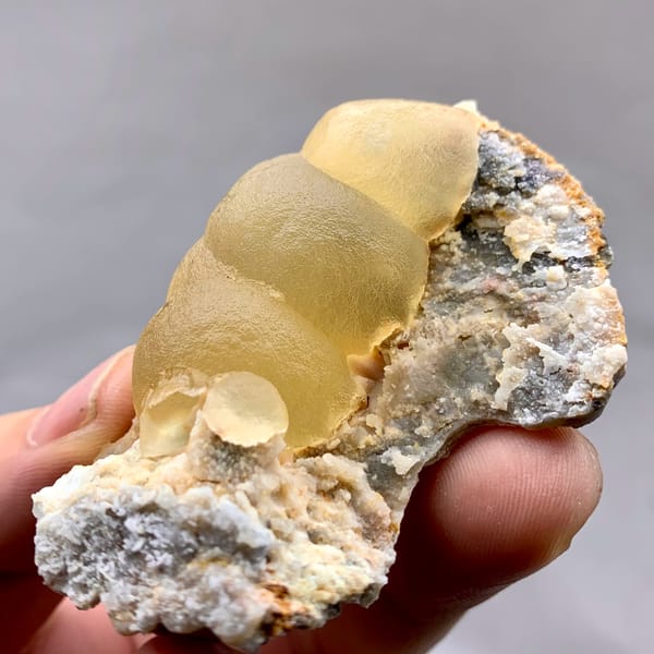 Large honey-yellow botryoidal fluorite ball on grey matrix from Henan, China, reverse side