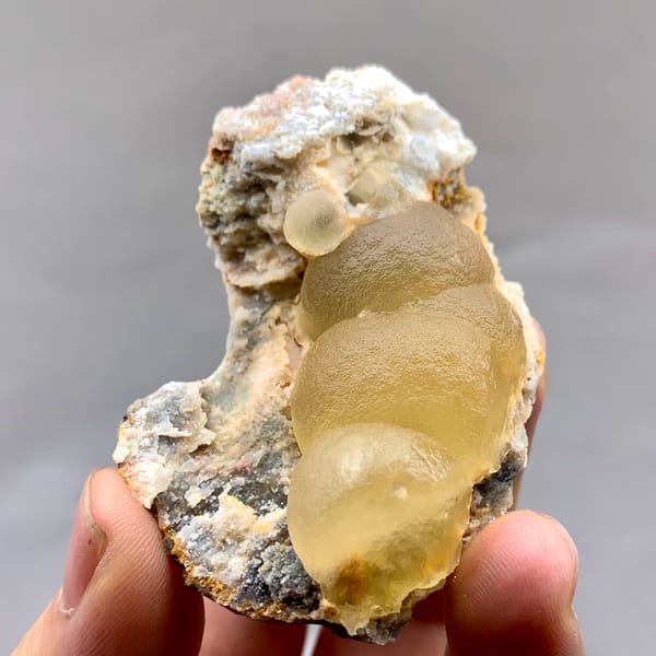 Large honey-yellow botryoidal fluorite ball on grey matrix from Henan, China, top view