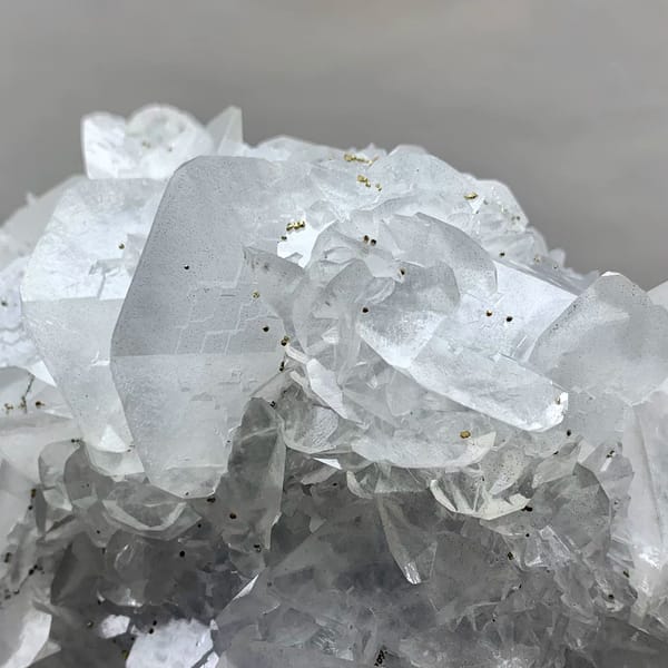 Large plate of glassy calcite blades with pyrite from Xianghualing, Hunan, China, close-up of the crystal faces