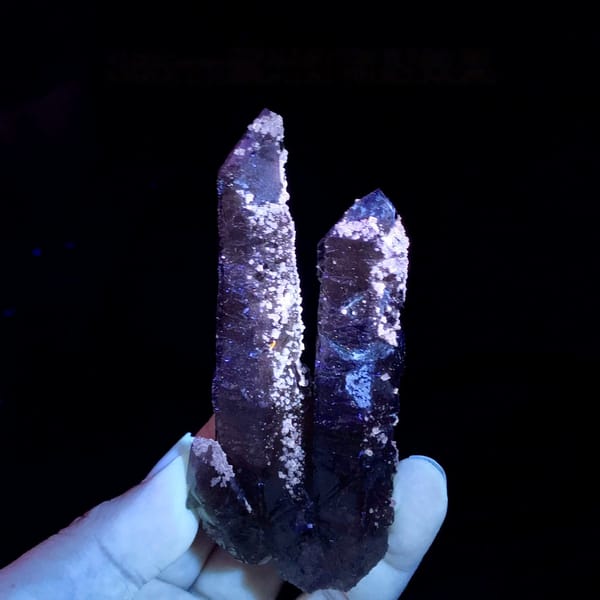 Two tea-brown quartz prisms with purple fluorite caps from Inner Mongolia, China, second angle