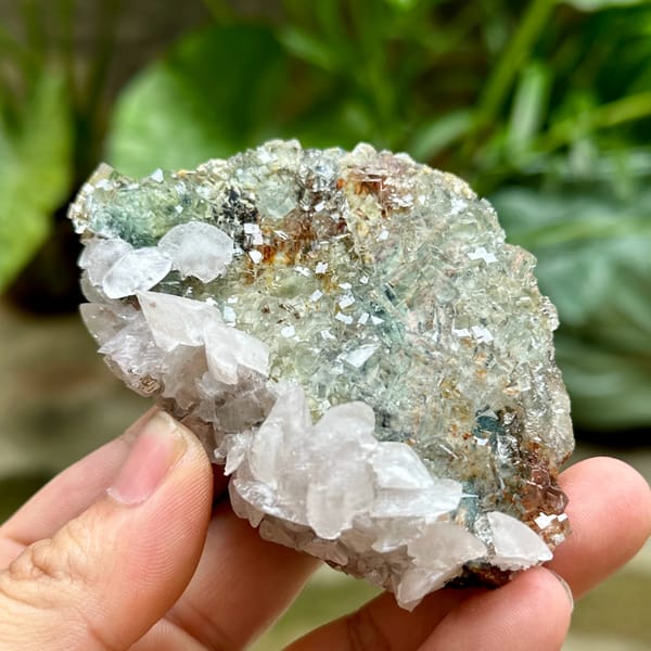 Glassy green fluorite cubes with white calcite and pyrolusite from Xianghualing, Hunan, China, close-up of the crystal faces