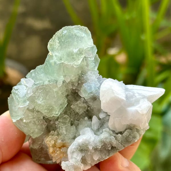 Glassy green fluorite over quartz with white calcite from Fujian, China, top view