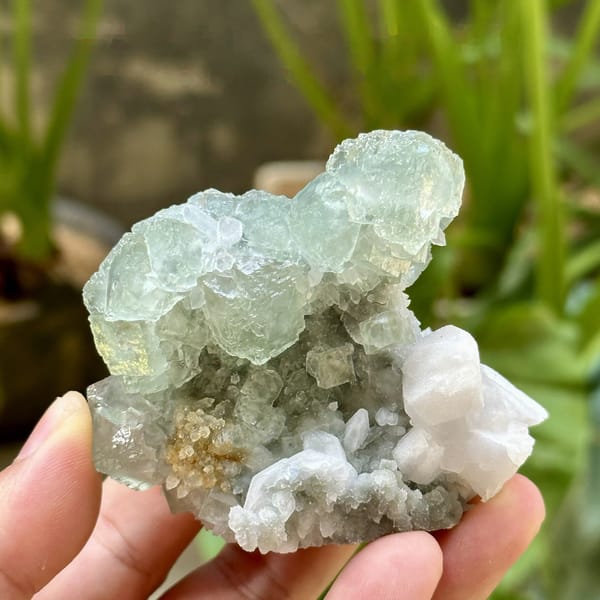 Glassy green fluorite over quartz with white calcite from Fujian, China, detail of the matrix contact