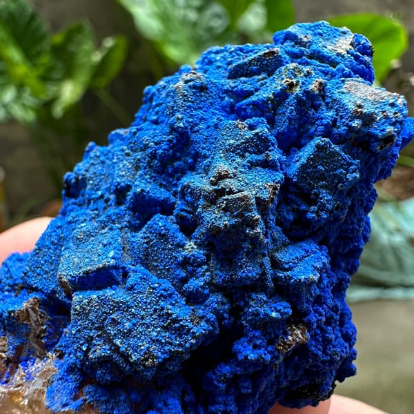 Electric-blue azurite crust covering fluorite from Yunnan, China, close-up of the crystal faces