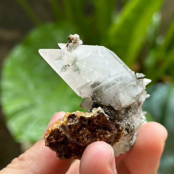 Double-terminated calcite crystal with fluorite octahedra on druse from Fujian, China, close-up of the crystal faces