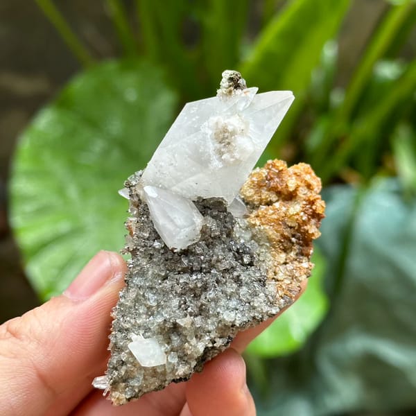 Double-terminated calcite crystal with fluorite octahedra on druse from Fujian, China, reverse side