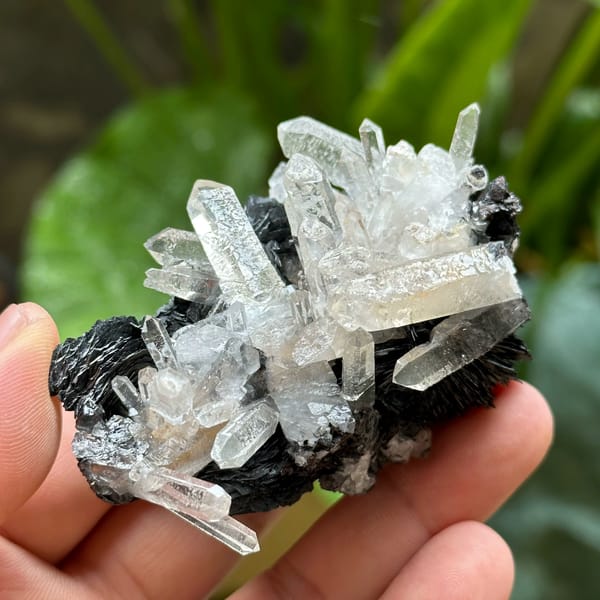 Etched clear quartz prisms on black specular hematite from Guangdong, China, second angle