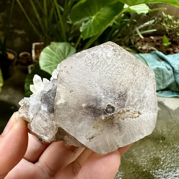 Large flat hexagonal calcite crystal with quartz from Fujian, China, detail of the matrix contact