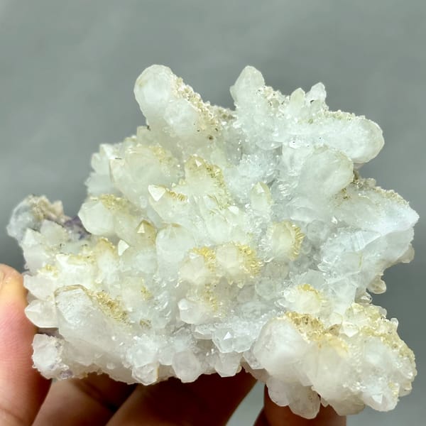Yellow-skinned quartz cluster with purple fluorite from Fujian, China, close-up of the crystal faces