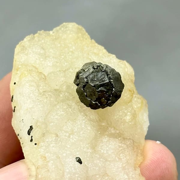 Black botryoidal pyrite ball on cream fluorite from Jiangxi, China, second angle