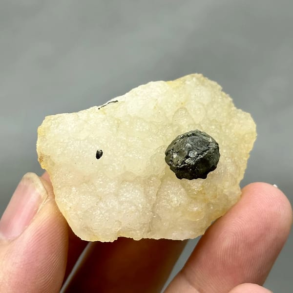 Black botryoidal pyrite ball on cream fluorite from Jiangxi, China, reverse side