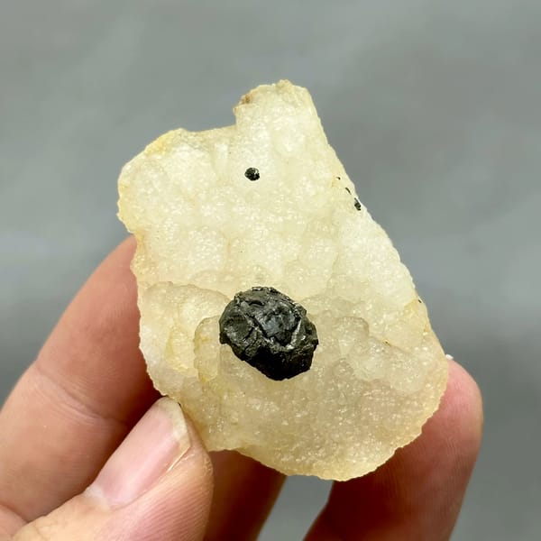 Black botryoidal pyrite ball on cream fluorite from Jiangxi, China, top view