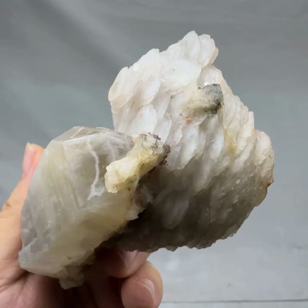 Pale quartz prism topped with layered white calcite from Inner Mongolia, China, reverse side