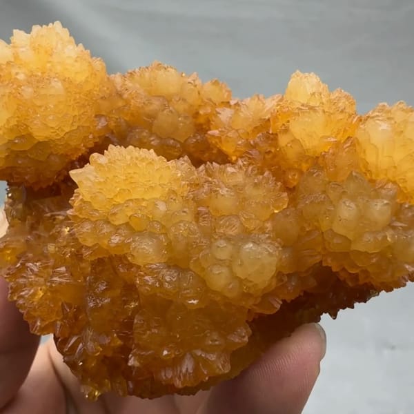 Golden-yellow botryoidal calcite balls from Guizhou, China, reverse side