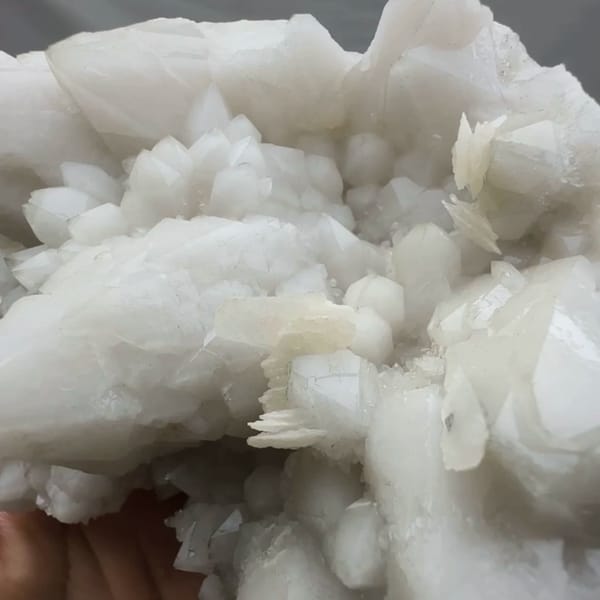 Chunky white quartz cluster with calcite from Xianghualing, Hunan, China, reverse side