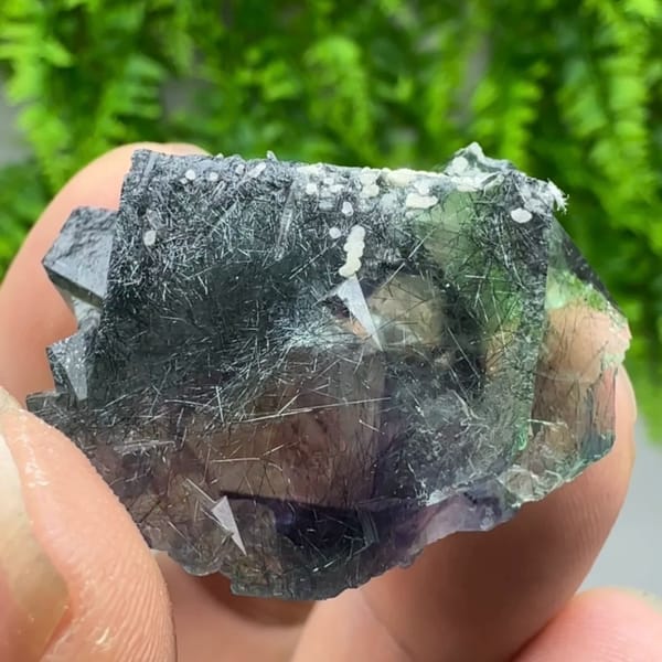 Clear phantom fluorite cubes enclosing bismuthinite needles from Inner Mongolia, China, second angle