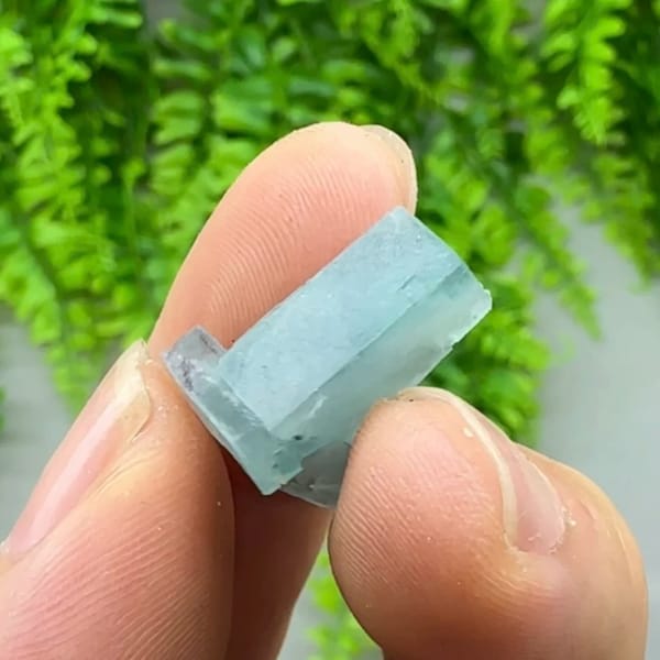 Tiny L-shaped blue-and-white fluorite crystal from Inner Mongolia, China, close-up of the crystal faces