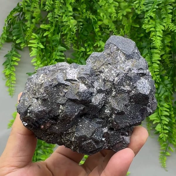 Heavy block of galena with sphalerite and pyrite from Peru, held in hand