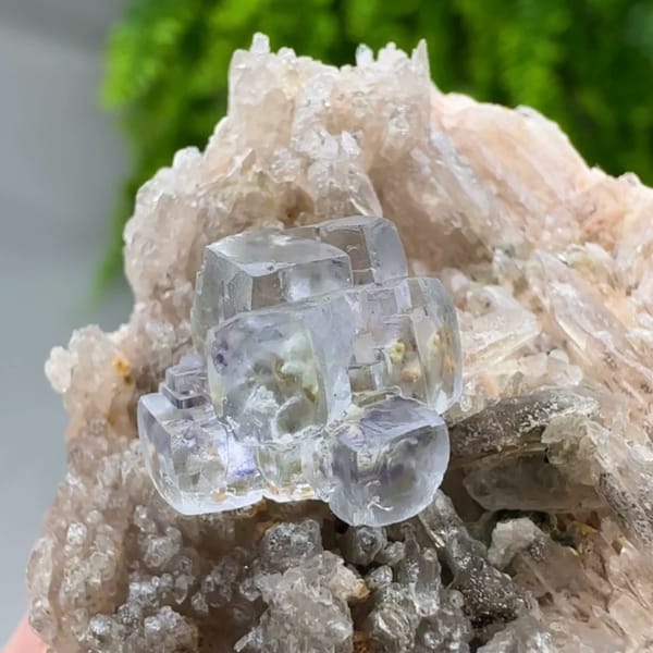 Pale blue combination-form fluorite crystals on quartz druse from Yunxiao, Fujian, China, close-up of the crystal faces