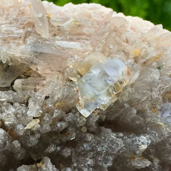 Pale blue combination-form fluorite crystals on quartz druse from Yunxiao, Fujian, China, top view