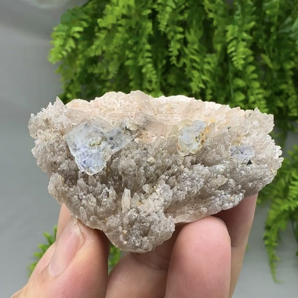 Pale blue combination-form fluorite crystals on quartz druse from Yunxiao, Fujian, China, detail of the matrix contact