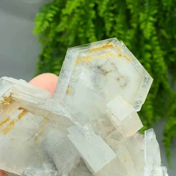 Stacked hexagonal calcite plates with orange growth lines from Fujian, China, close-up of the crystal faces