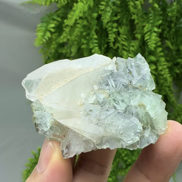Transparent green fluorite octahedra with white calcite blade from Fujian, China, detail of the matrix contact