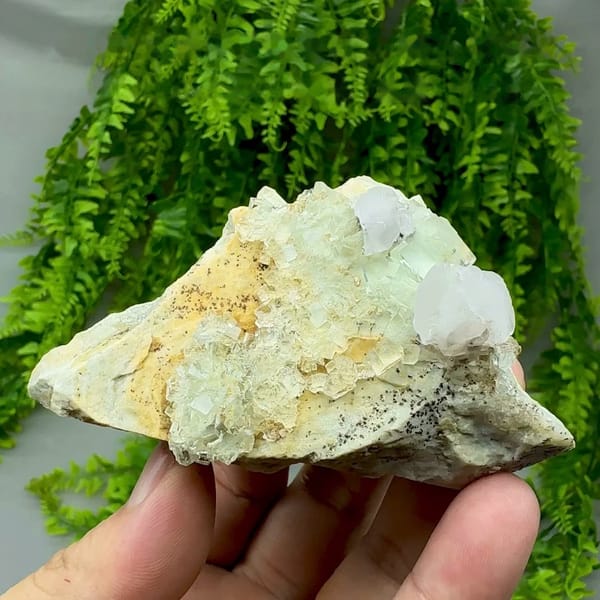 White calcite crystal on glassy green fluorite with pyrolusite from Xianghualing, Hunan, China