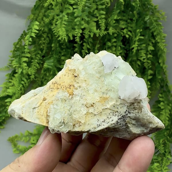 White calcite crystal on glassy green fluorite with pyrolusite from Xianghualing, Hunan, China, detail of the matrix contact