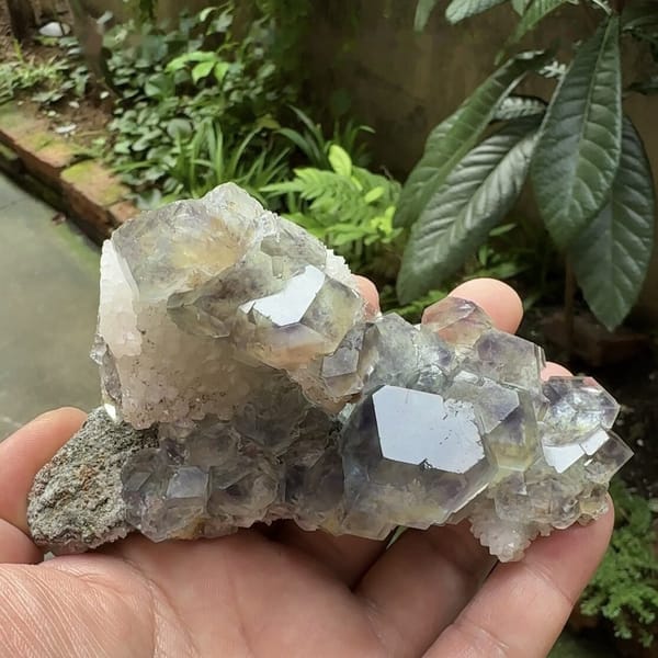 Glassy blue-green fluorite dodecahedra along quartz ridge from Fujian, China, close-up of the crystal faces