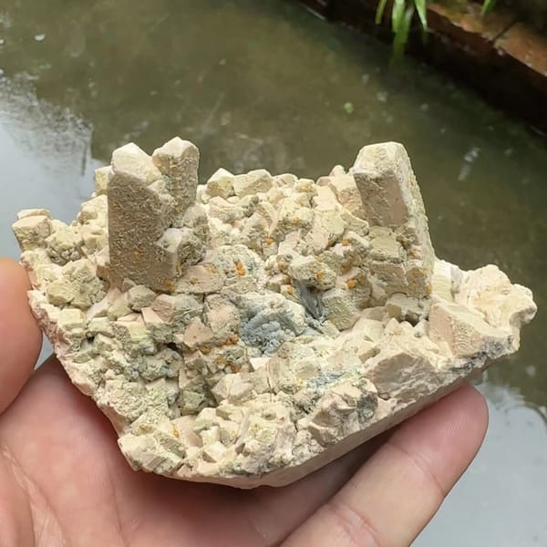 Tan feldspar towers with chabazite and bismuthinite from Yunxiao, Fujian, China, close-up of the crystal faces