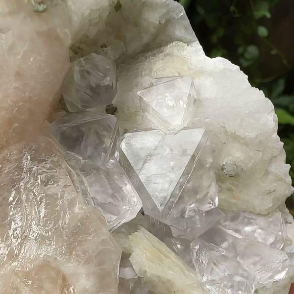 White fluorite octahedra with calcite prism and quartz from Inner Mongolia, China, close-up of the crystal faces