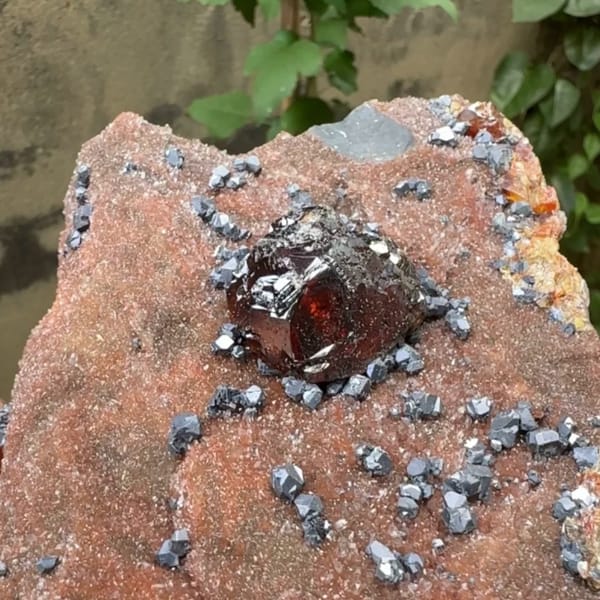 Large gem sphalerite crystal with galena on red-brown quartz from Hunan, China, close-up of the crystal faces
