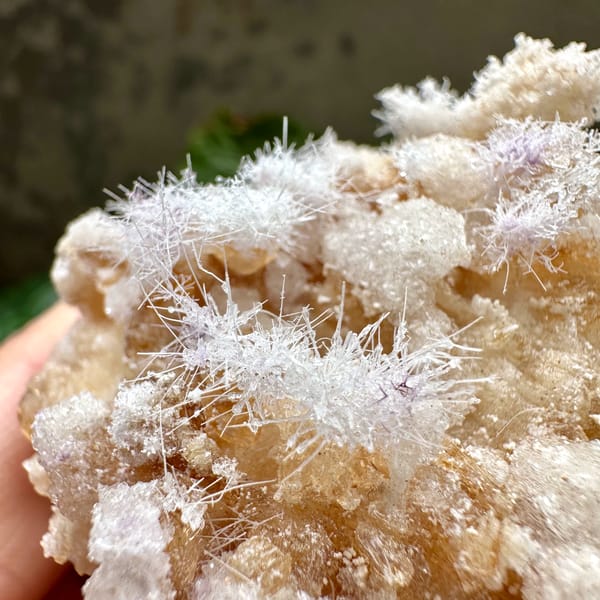Fuzzy white aragonite tufts over yttrofluorite and gypsum from Guizhou, China, second angle