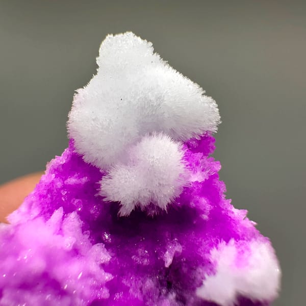 Vivid magenta aragonite with white aragonite tufts from Yunnan, China, second angle