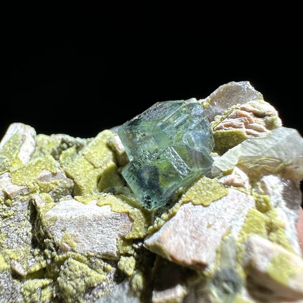 Green fluorite octahedron on yellow-green mica and feldspar from Yunxiao, Fujian, China, reverse side