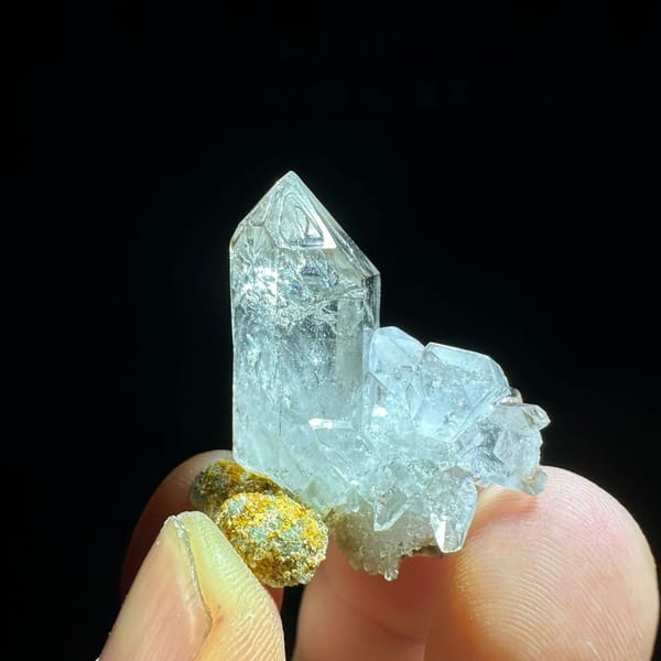Water-clear window-faced diamond quartz crystal from Sichuan, China, held in hand