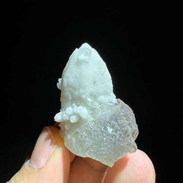Pale blue-green fluorite enclosing candle quartz from Inner Mongolia, China, close-up of the crystal faces