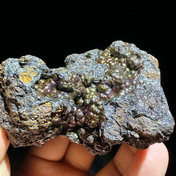 Iridescent multicoloured botryoidal limonite from Guizhou, China, close-up of the crystal faces