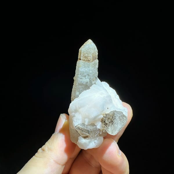 Slender frosted quartz prism with white calcite blade from Inner Mongolia, China, close-up of the crystal faces