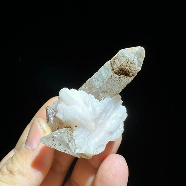 Slender frosted quartz prism with white calcite blade from Inner Mongolia, China, top view