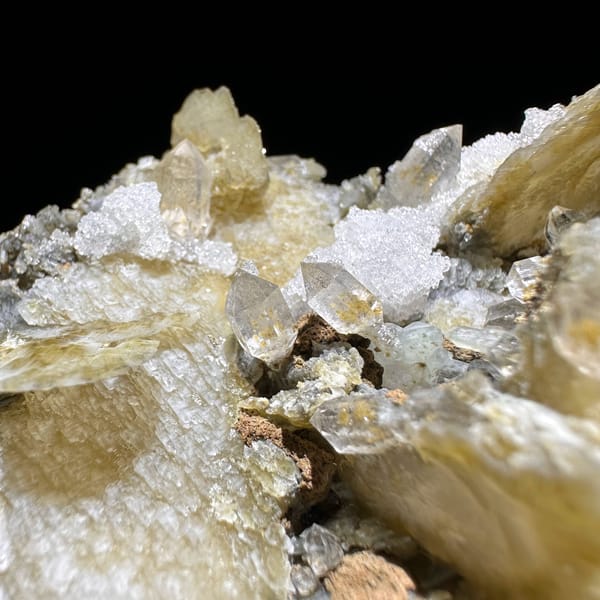 Phantom scepter quartz among tan platy calcite from Inner Mongolia, China, reverse side