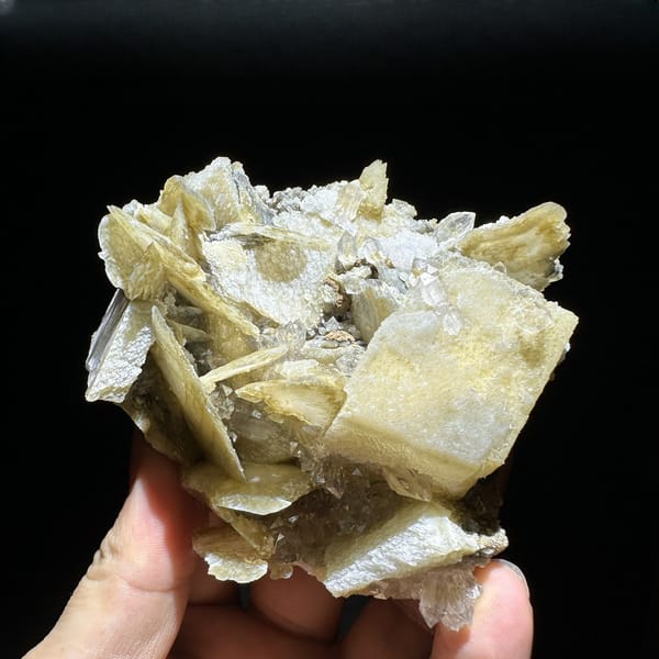Phantom scepter quartz among tan platy calcite from Inner Mongolia, China, detail of the matrix contact