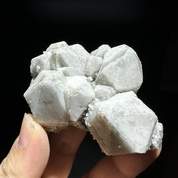 Large blocky white quartz crystals with bright skin from Inner Mongolia, China, detail of the matrix contact