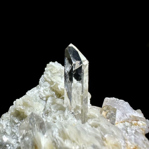 Clear quartz point standing in pearly muscovite from Xuebaoding, Sichuan, China, second angle