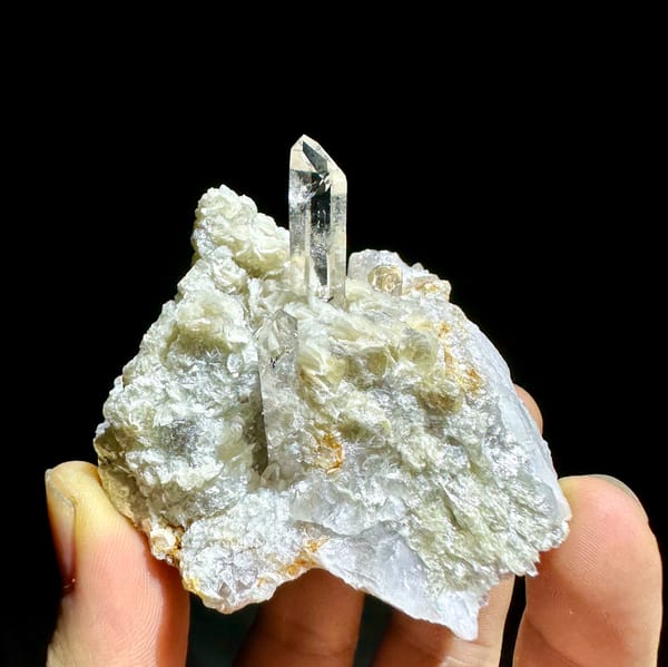 Clear quartz point standing in pearly muscovite from Xuebaoding, Sichuan, China, reverse side
