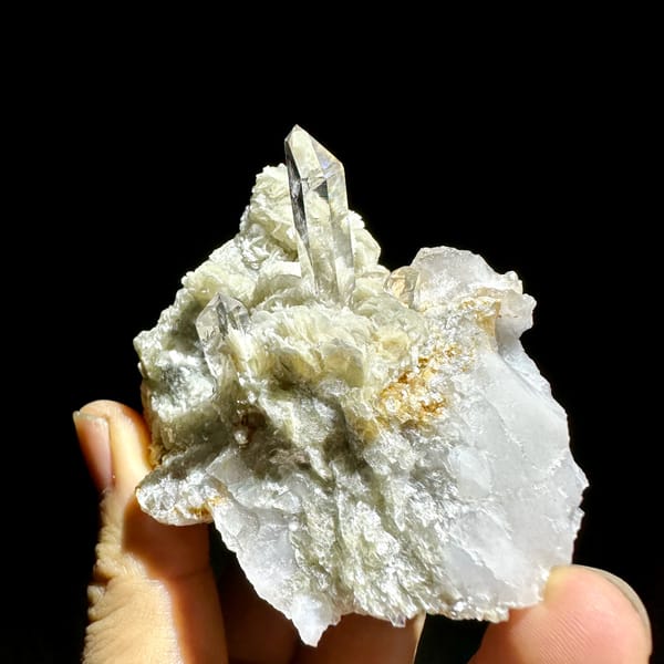 Clear quartz point standing in pearly muscovite from Xuebaoding, Sichuan, China, top view