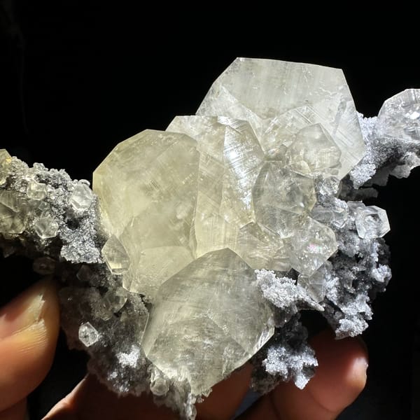 Glassy transparent calcite crystals on dark grey quartz from Fujian, China, reverse side